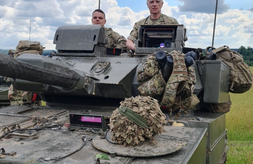 Rob Butler MP in military vehicle 