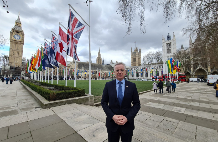 Rob in Parliament Square with the flags of the Commonwealth