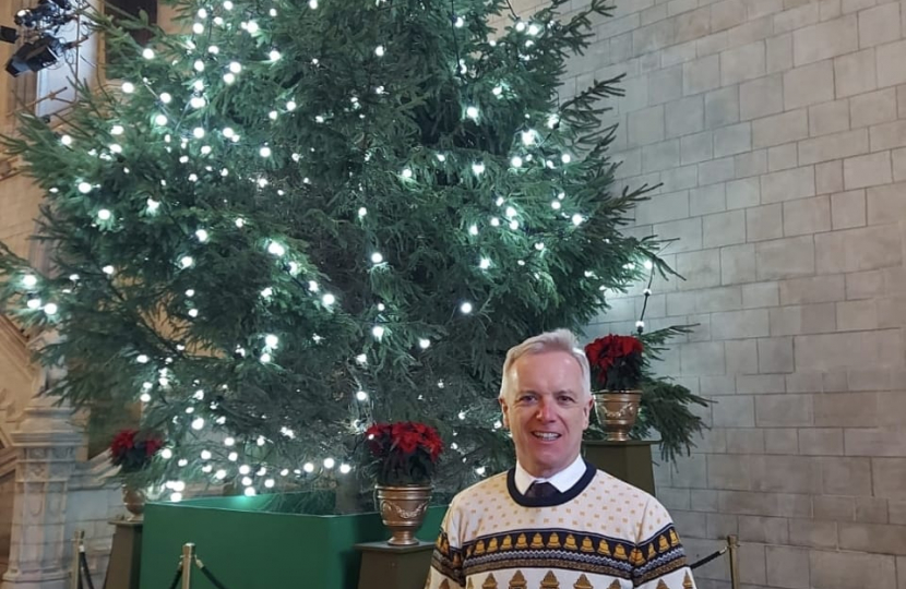 Rob in front of a Christmas Tree in Parliament 
